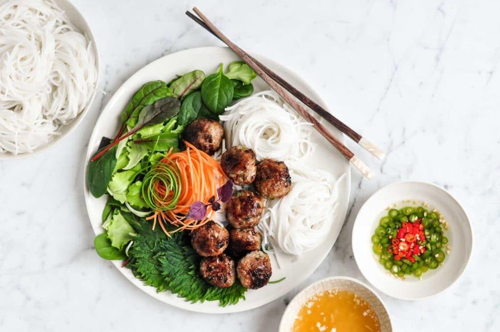  Freshly chopped herbs add vibrant colors and flavors to this Vietnamese Grilled Pork Meatballs and Noodle Bowl.