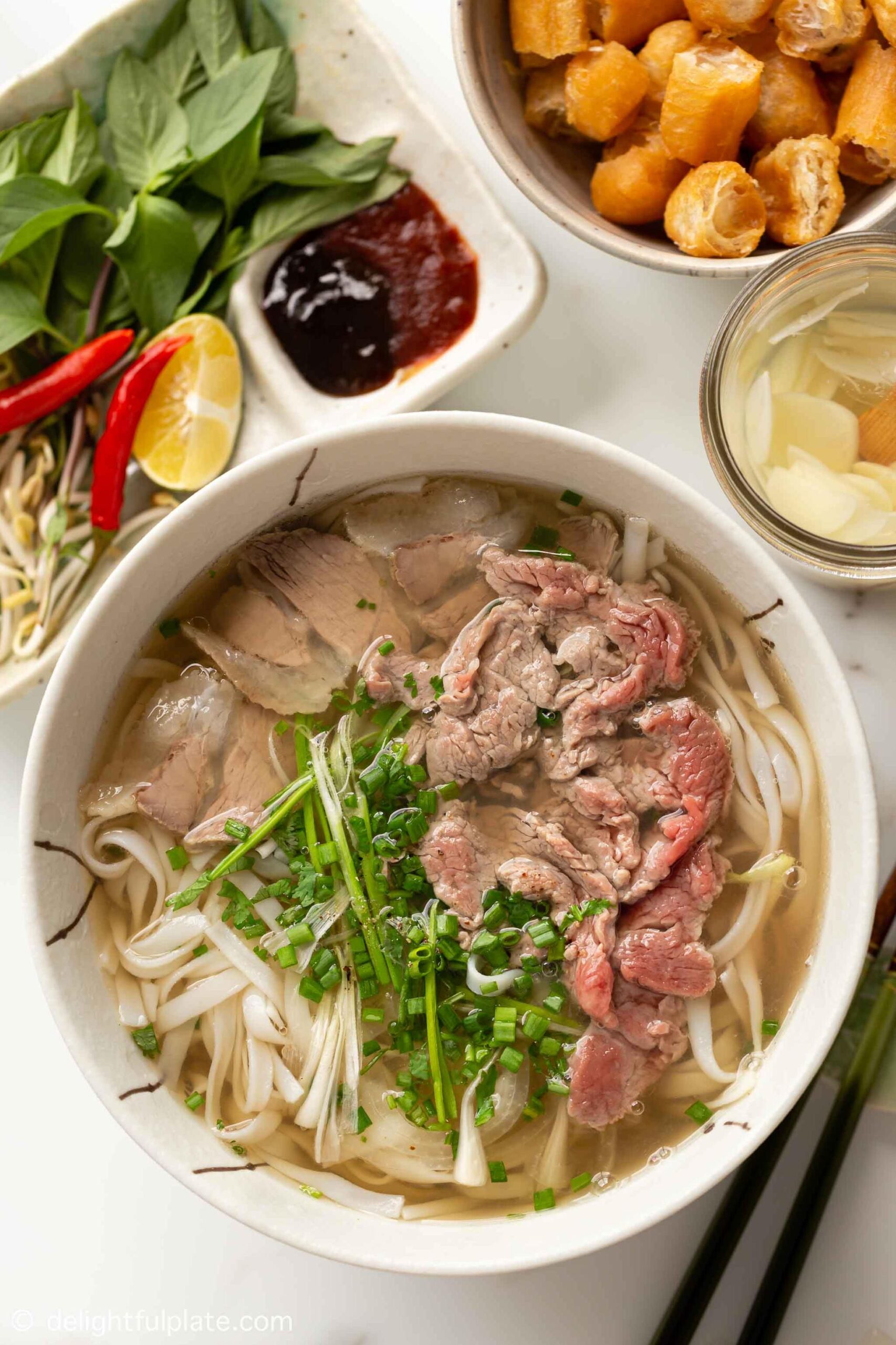  Let the aroma of star anise and cinnamon fill your kitchen as you prepare this beloved Vietnamese classic.
