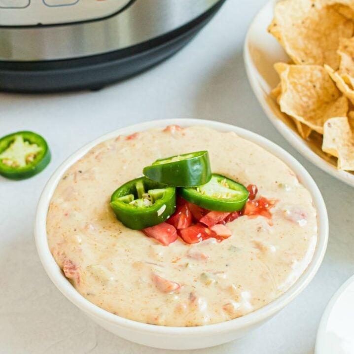  Melting cheese, green chilies, and tomatoes creating a perfect dip.