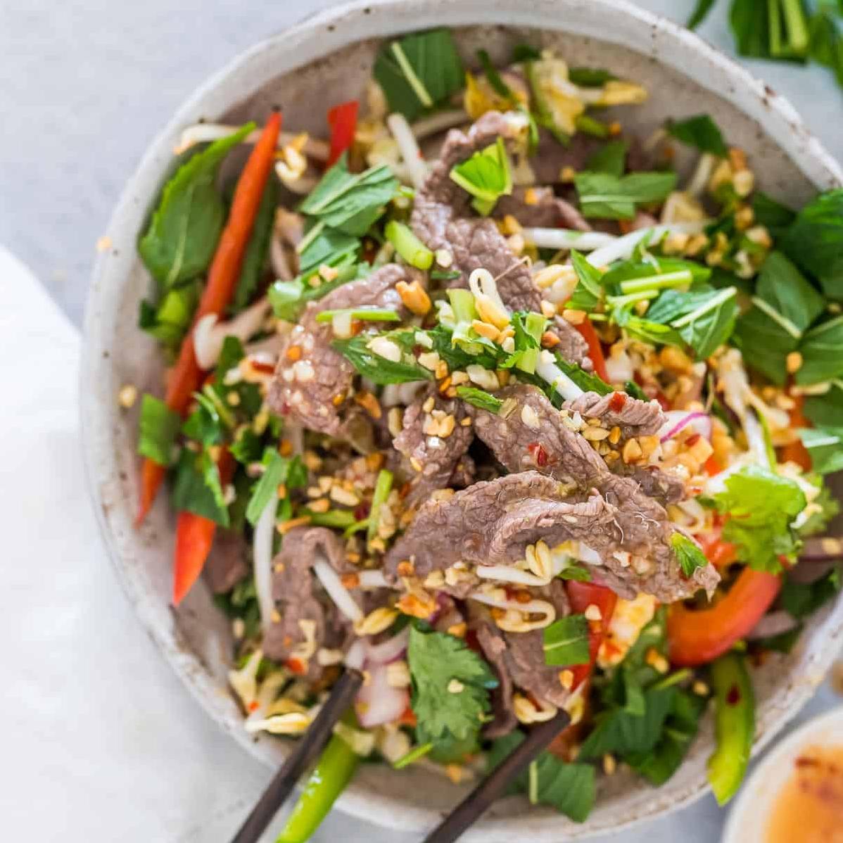  Tender, juicy beef strips mingle with mint, lettuce, and other savory toppings in this Vietnamese salad.