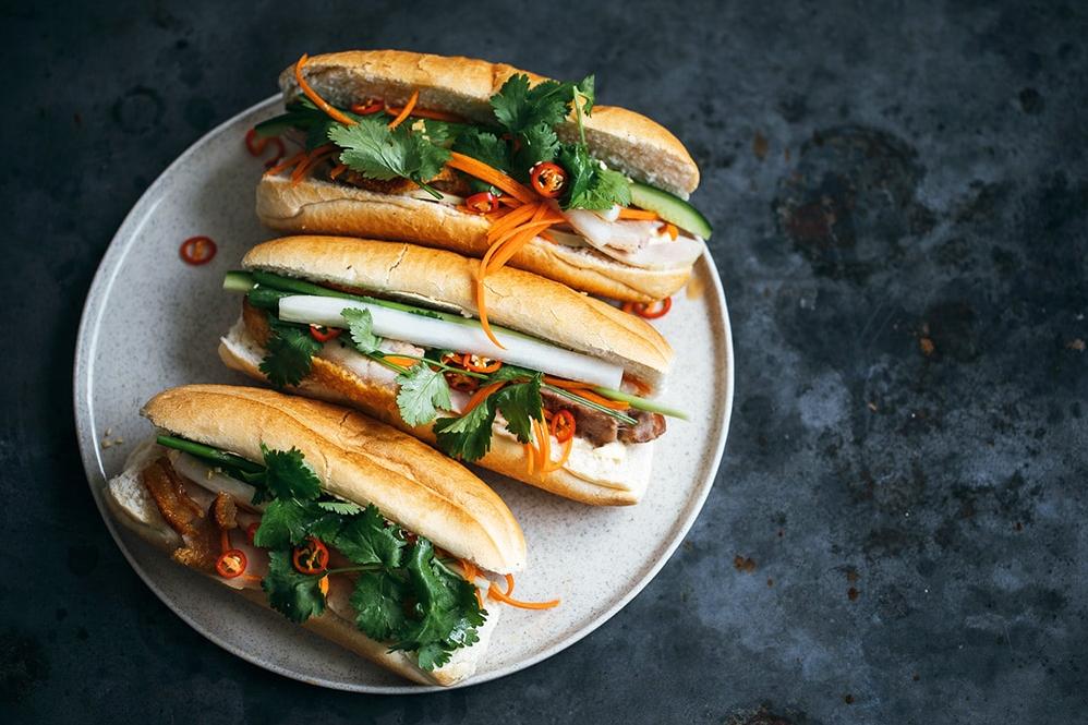 The perfect combo of crispy bread, juicy pork, and pickled veggies in one sandwich